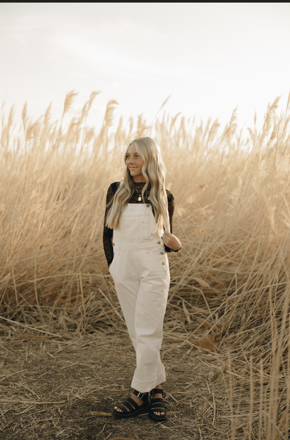 Hayleebhair Salon stylist in a sunlit field of wheat